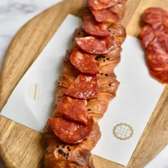 A Spanish Chorizo Twisty, a savory pastry from our limited-edition pop-up menu. The spicy chorizo is twisted into our buttery, flaky dough.