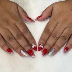 A fun and festive set perfect for the holidays. Bright red nails are paired with silver glitter and cute 3D silver bows for a playful touch.