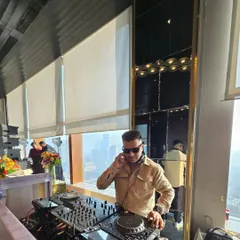 Playing a sundowner set at a high-rise venue with a stunning city view. The music selection for these events is curated to be chic and sophisticated.