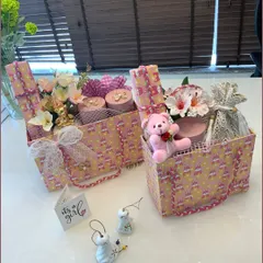 A lovingly chosen collection of wonders for a baby girl. This hamper, themed in pink and yellow, showcases our attention to detail with delicate lace bows and a charming assortment of gifts.