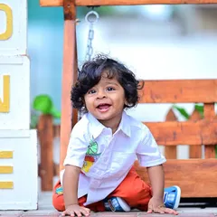 A happy one-year-old boy next to "ONE" blocks during an outdoor shoot.