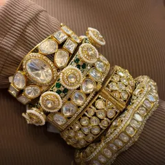 Bangles that blend craft and charm. A close-up of a luxurious stack of polki bangles, showcasing different widths and designs.