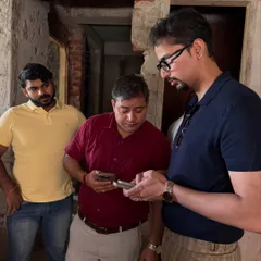 On-site discussions are crucial. Here, our team is coordinating with contractors inside a raw construction space, ensuring that the plans are being followed and addressing any immediate challenges that arise during the build.