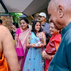 The smiles and interactions between guests are just as important as the main ceremony. This photo captures the warm atmosphere of the family gathering.