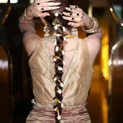 A stunning and unique bridal braid, woven with ribbon and decorated with cowrie shells. This is the kind of creative hairstyling we explore.