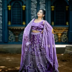This unique purple lehenga comes with a stylish cape-style dupatta. The silver embroidery on the rich purple fabric creates a modern yet regal look.