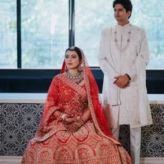 A stunning portrait of the bride and groom. Her makeup was meticulously applied to look flawless both in person and for professional portraits, ensuring her look was timeless and elegant next to her groom's classic white sherwani.