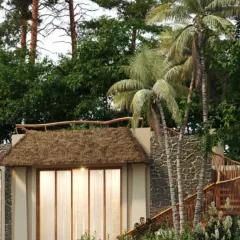 This view highlights the integration of indoor and outdoor living at the Dev Villas. Large sliding doors open onto a private deck, while a wooden staircase leads to an upper level, all surrounded by lush palm trees and pines.