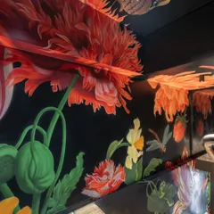 This hand-painted floral mural wraps around the restaurant's staircase, creating a continuous journey of discovery. I used a mix of poppies, tulips, and other wildflowers against a dark background to build a sense of moody, botanical wonder.