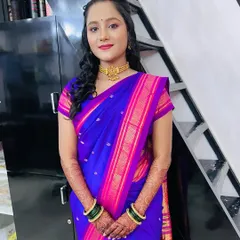 A full portrait of the client in a beautiful blue and pink saree. This look is elegant and perfect for a wedding guest.