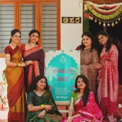 A "Maduve Mane" or "Wedding Home" welcome sign in Kannada, surrounded by the happy women of the family. I love adding these personal, local touches to make the celebration feel truly like home.