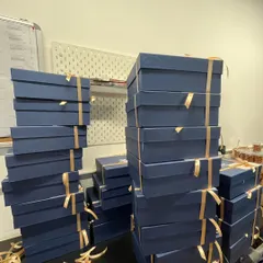 Stacks on stacks of corporate gift boxes ready to go. This image shows our capacity to handle large-volume orders, ensuring each one is packed consistently and beautifully with a hand-tied ribbon.