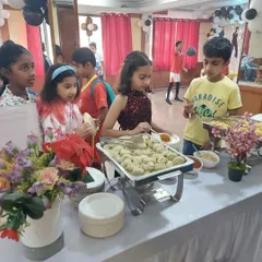 Kids enjoying the buffet I set up. Here they are helping themselves to a tray of delicious momos, a popular choice that I often include in my party menus.