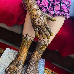 A stunning view of a complete bridal henna set after the paste has been removed. The rich, dark stain is clearly visible on both the hands and feet.