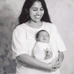 I love the genuine joy in this black and white photo. A mother laughs as she holds her expressive newborn, creating a candid and heartwarming memory that feels incredibly authentic.