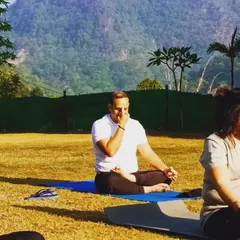 A student practices Nadi Shodhana (Alternate Nostril Breathing) during our yoga retreat in Rishikesh. The serene mountain environment enhances the calming effects of pranayama.