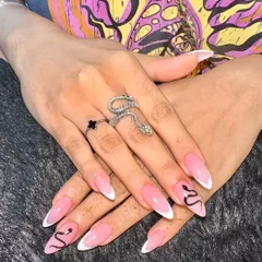 For a look that's a little more edgy, I created this snake-themed nail art. It combines a classic white French tip with a detailed, hand-painted black snake that winds its way across two accent nails.