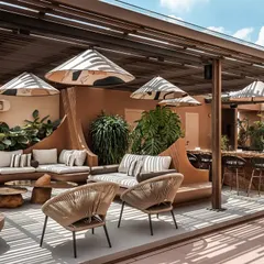 A sunlit daytime view of the Terra Gardens project, revealing the thoughtful zoning of the space. The slatted pergola creates a beautiful play of light and shadow over the social lounge and outdoor kitchen, while the open design maintains a connection to the city skyline beyond.