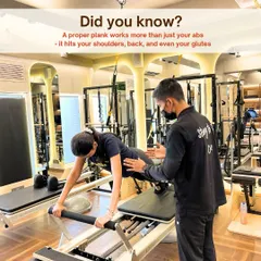 Form is everything. Our hands on approach ensures you perform each movement safely and effectively, like perfecting this plank on the Reformer to engage the entire core.
