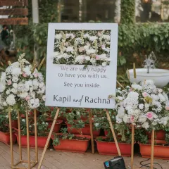 A warm and personal welcome for guests at this dreamy reception. The sign, framed by beautiful pastel floral arrangements, set the tone for a memorable and heartfelt evening.