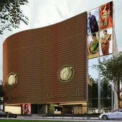 A concept render for The Chennai Silks flagship store, featuring a curved facade clad in a "metal drape" of terracotta-colored tiles. The design aims to create a modern landmark that reflects the brand's heritage.