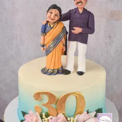 This cake was part of a trio for a combined anniversary celebration, featuring a custom couple topper in traditional attire. I'm getting better at draping these tiny fondant sarees with every cake I make!