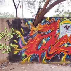 Another view of the tree piece, showing how the fiery red letters seem to be fueled by the tree itself. It's about co-existing with nature.