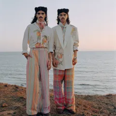 A full-length shot of the two models, with the vast ocean behind them. The composition emphasizes a sense of freedom and connection, which was the core theme of this editorial.