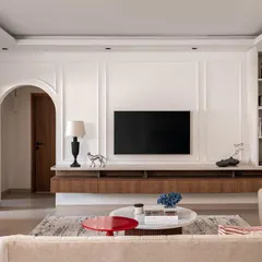 This living room from 'Project Dolce' was designed for a young family, blending contemporary style with practical needs. The space features clean lines, wall paneling for texture, and a floating console to maintain an open feel, proving that a family home can be both sophisticated and functional.