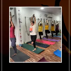 Students holding Vrikshasana (Tree Pose) in a line, focusing on their balance and stability.