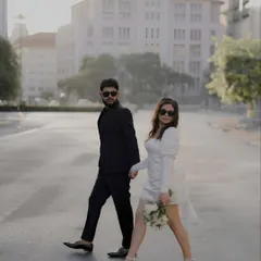 There is a certain magic to an empty city street at dawn. For this shoot, we embraced a modern, chic aesthetic, creating images that feel like stills from a contemporary film. The contrast of their black and white outfits against the urban architecture tells a story of confident, stylish love.
