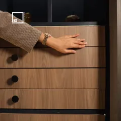 A close-up of a push-to-open drawer, demonstrating the smooth, hardware-free front. This type of detail is key to achieving a minimalist aesthetic while ensuring the furniture is easy to use.