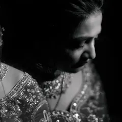 A soft, intimate black and white photograph of a bride and her loved one sharing a quiet moment before the ceremony. These are the precious, unscripted memories I love to preserve.