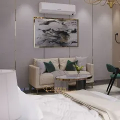 A bedroom featuring a minimalist seating area and sleek, handle-less wardrobes that blend into the wall, creating a clean and uncluttered look.