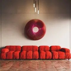 A direct shot of the red 'Radiant Circles' art, emphasizing its vibrant color and the mesmerizing pattern created by the radiating wooden slats.