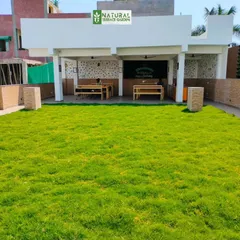 A completed rooftop project in Dwarka Mor featuring an expansive natural lawn, perfect for events or as a play area.