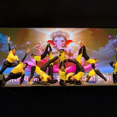 This synchronized pose shows the unity and discipline of the team. Each student plays a crucial part in creating the final beautiful shape.