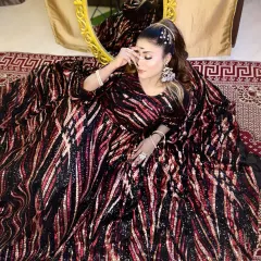 A full-length shot from a portfolio shoot, showcasing a dramatic gown and complementary makeup.