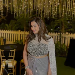 For this engagement party, we went for sheer elegance. The look features glowing, glass-like skin and soft smoky eyes, paired with a modern draped saree and voluminous waves for a super glam finish.