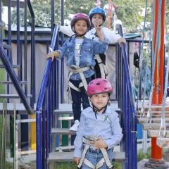 Safety first, then adventure! Here, our little explorers are fully harnessed and ready to take on the challenges of our multi-level high ropes course.