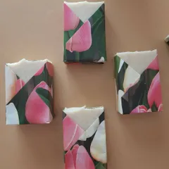 Soaps dressed in their floral paper tuxedos, ready to be shipped. This packaging protects the soap while being completely sustainable and lovely to look at.