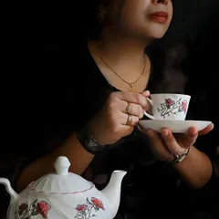 A moody self-portrait capturing the steam rising from a teacup. I used dark, dramatic lighting to create a sense of peace and introspection in this creative shot.