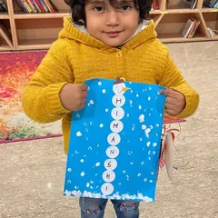 Such a happy face from our winter camp. This little artist is so proud of her snowman name craft, a fun activity where we learned to spell our names while creating winter art.