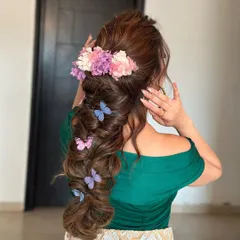 A whimsical textured mehendi braid adorned with flowers and butterflies. This look is pure magic, and the volume from the extensions is what makes it so breathtaking.