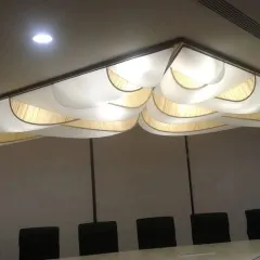 This unique ceiling fixture in the RGA Tech Park features layered, wave-like forms. This design helps to diffuse sound in the conference room below while acting as a decorative light source.