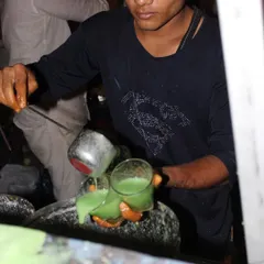A staff member carefully preparing a refreshing green juice. Our juice bar is a popular feature, offering a healthy and tasty beverage option for guests.