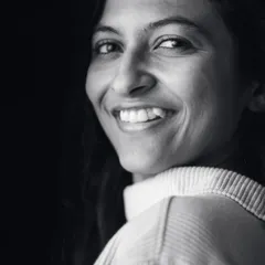 A warm, genuine smile captured in a monochrome portrait. This image shows a softer, more approachable side of my boudoir work, focusing on natural expression.