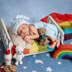 Dreaming in a rainbow bed. This colorful and cheerful setup, complete with milk and cookies, is perfect for celebrating your rainbow baby or just for a bright and happy portrait.