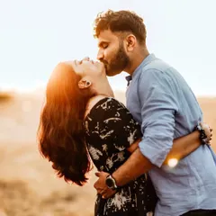 A tender kiss against a sun-drenched backdrop captures the pure romance of this couple's journey. I aim for these unposed, emotional moments during my outdoor couple photoshoots, letting the golden hour light add a touch of magic.