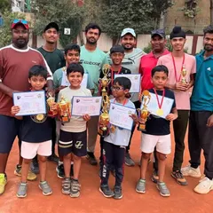 The coaches and our champion players posing together after a successful tournament. This picture shows the strong bond we share and the collective effort that goes into every win.